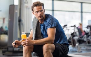 young man working out with the best beta hydroxybutyrate drink in his hand