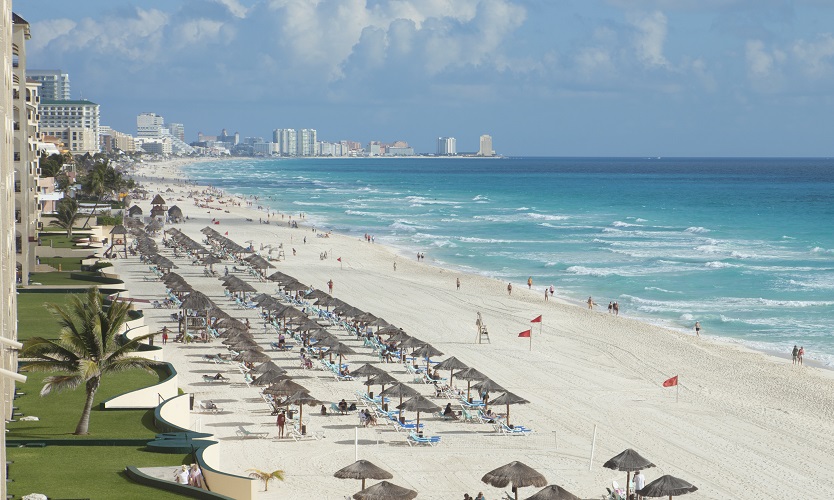 A view along the beach of the Caribbean Sea and hotels in Cancun, Mexico